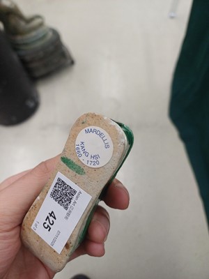 Lot 425 - Three Chinese biscuit famille-verte models of shoes, Qing dynasty, Kangxi period