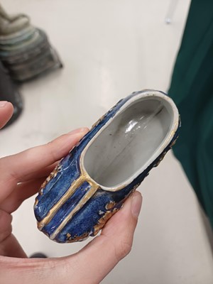 Lot 425 - Three Chinese biscuit famille-verte models of shoes, Qing dynasty, Kangxi period