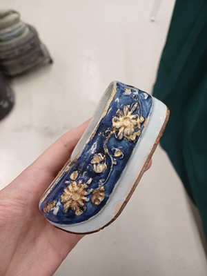 Lot 425 - Three Chinese biscuit famille-verte models of shoes, Qing dynasty, Kangxi period