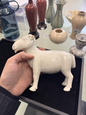 Lot 476 - A Chinese white-glazed figure of a ram, Qing dynasty, Qianlong period