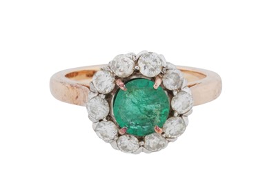 Lot 90 - An emerald and diamond halo ring