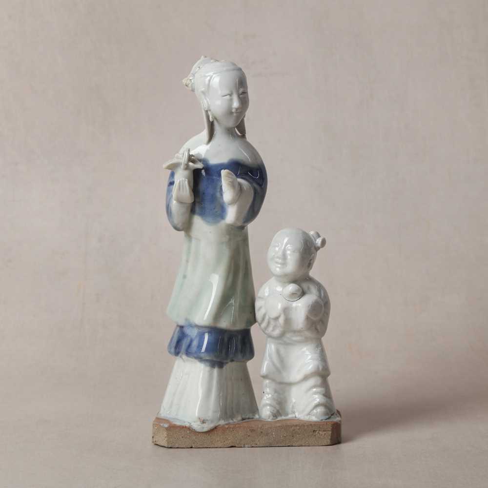 Lot 38 - A Chinese glazed-biscuit 'lady and child' figure group, Qing dynasty, Qianlong period