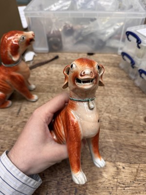 Lot 54 - A pair of fine Chinese export 'seated hounds' figures, Qing dynasty, Qianlong period