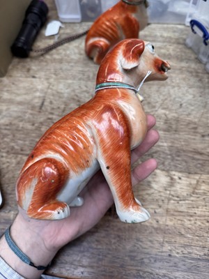 Lot 54 - A pair of fine Chinese export 'seated hounds' figures, Qing dynasty, Qianlong period