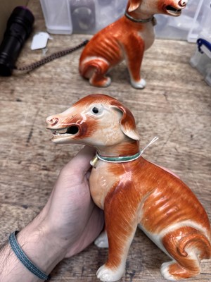 Lot 54 - A pair of fine Chinese export 'seated hounds' figures, Qing dynasty, Qianlong period