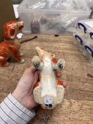 Lot 54 - A pair of fine Chinese export 'seated hounds' figures, Qing dynasty, Qianlong period