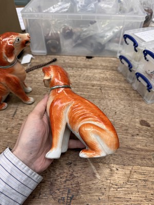 Lot 54 - A pair of fine Chinese export 'seated hounds' figures, Qing dynasty, Qianlong period