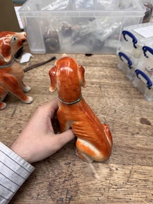 Lot 54 - A pair of fine Chinese export 'seated hounds' figures, Qing dynasty, Qianlong period