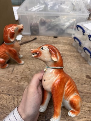 Lot 54 - A pair of fine Chinese export 'seated hounds' figures, Qing dynasty, Qianlong period
