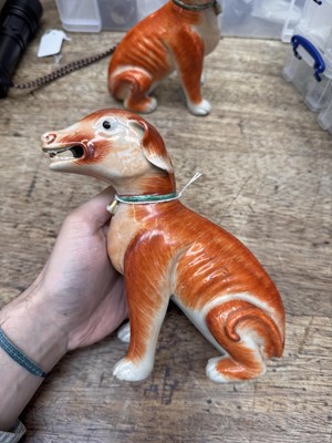 Lot 54 - A pair of fine Chinese export 'seated hounds' figures, Qing dynasty, Qianlong period