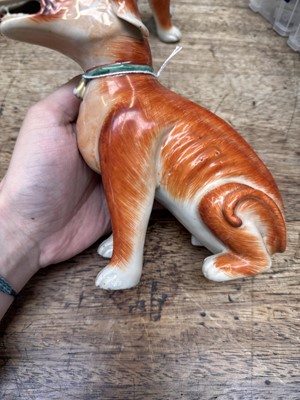 Lot 54 - A pair of fine Chinese export 'seated hounds' figures, Qing dynasty, Qianlong period