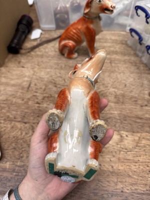 Lot 54 - A pair of fine Chinese export 'seated hounds' figures, Qing dynasty, Qianlong period