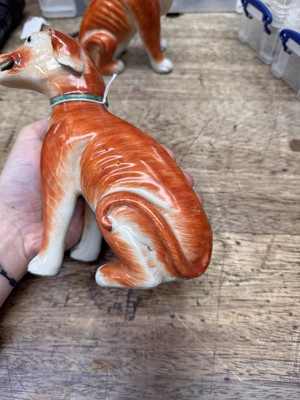 Lot 54 - A pair of fine Chinese export 'seated hounds' figures, Qing dynasty, Qianlong period