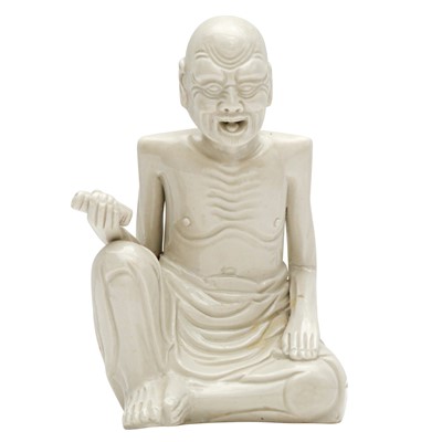 Lot 609 - A Chinese white-glazed figure of Emaciated Luohan, Qing dynasty