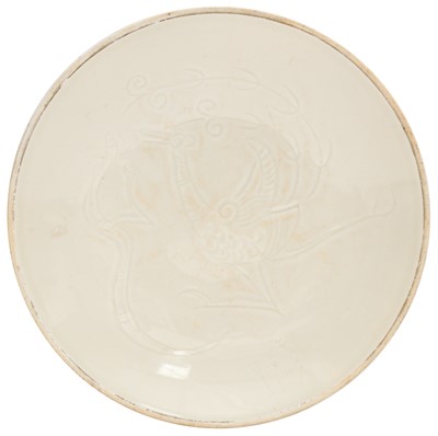 Lot 676 - A Chinese Ding-style white-glazed 'phoenix' dish, 20th century