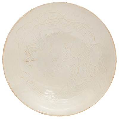 Lot 675 - A Chinese Ding-style white-glazed 'dragon' dish, 20th century