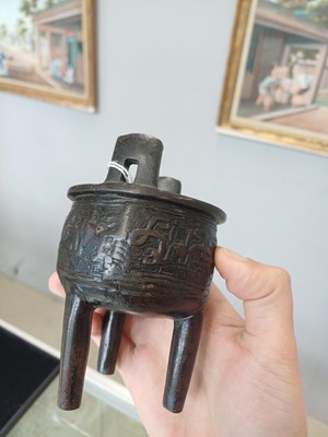 Lot 663 - A SMALL CHINESE ARCHAISTIC BRONZE TRIPOD CENSER