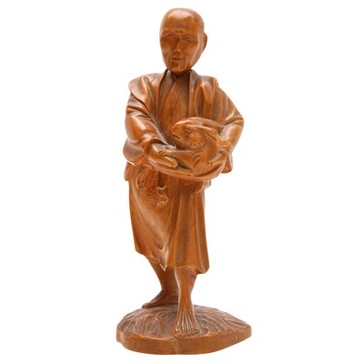 Lot 117 - A Japanese boxwood carving of a man holding a rabbit, 19th century