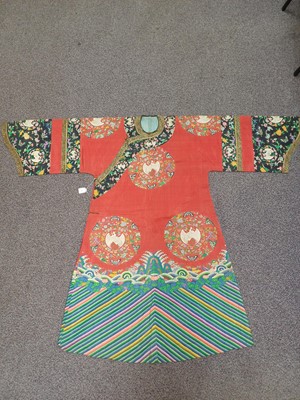 Lot 131 - A CHINESE MANCHU NOBLEWOMAN'S INFORMAL KESI SILK RED-GROUND ROBE, DANPAO