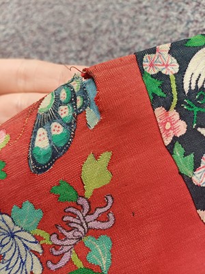 Lot 131 - A CHINESE MANCHU NOBLEWOMAN'S INFORMAL KESI SILK RED-GROUND ROBE, DANPAO