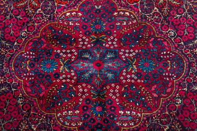 Lot 82 - AN ANTIQUE KIRMAN LAVER RUG, SOUTH PERSIA