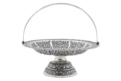 Lot 217 - A mid-20th century Cambodian unmarked silver swing handled basket, circa 1960