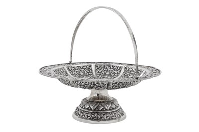 Lot 217 - A mid-20th century Cambodian unmarked silver swing handled basket, circa 1960