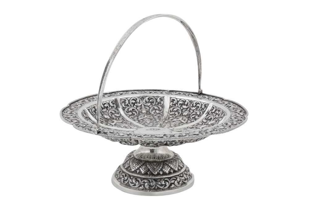 Lot 217 - A mid-20th century Cambodian unmarked silver swing handled basket, circa 1960