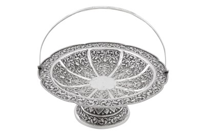 Lot 217 - A mid-20th century Cambodian unmarked silver swing handled basket, circa 1960