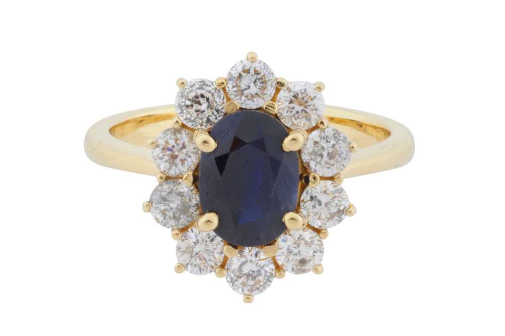 Lot 76 - A sapphire and diamond cluster ring