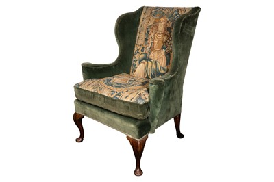 Lot 326 - A wing back armchair