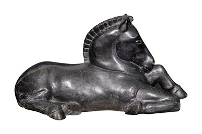 Lot 159 - A large Tang style carved hard stone sculpture of a recumbent horse