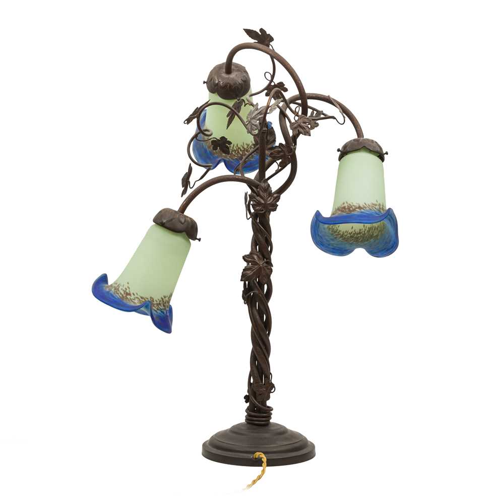 Lot 268 - A French Art Nouveau Style Wrought Iron and Glass Table Lamp