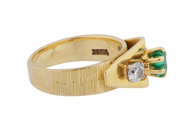 Lot 84 - An emerald and diamond three-stone ring