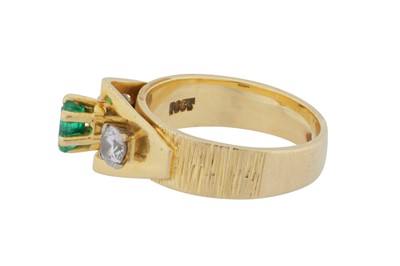 Lot 84 - An emerald and diamond three-stone ring