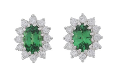 Lot 86 - A pair of tsavorite garnet and diamond cluster earrings