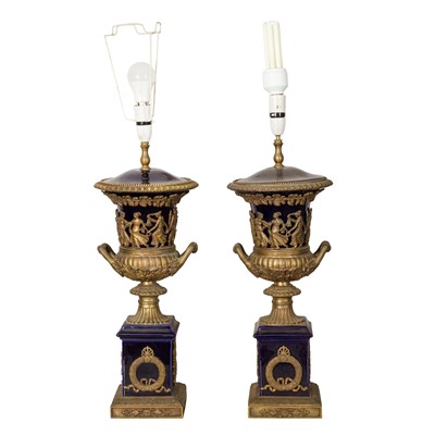 Lot 255 - A pair of Neo-Classical style gilt metal and ceramic table lamps
