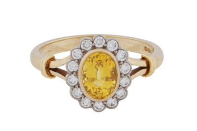 Lot 261 - A yellow sapphire and diamond cluster ring, circa 2002