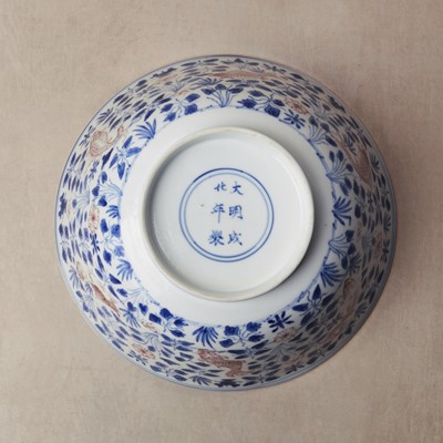 Lot 12 - A Chinese blue and white and copper-red 'fish' bowl, Qing dynasty, Kangxi period