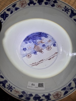 Lot 12 - A Chinese blue and white and copper-red 'fish' bowl, Qing dynasty, Kangxi period