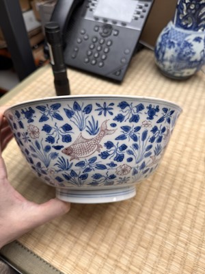Lot 12 - A Chinese blue and white and copper-red 'fish' bowl, Qing dynasty, Kangxi period