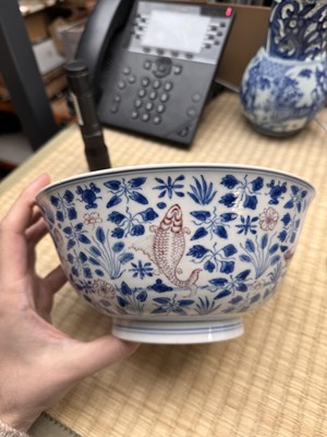 Lot 12 - A Chinese blue and white and copper-red 'fish' bowl, Qing dynasty, Kangxi period
