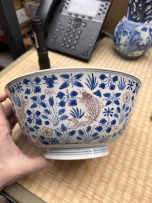 Lot 12 - A Chinese blue and white and copper-red 'fish' bowl, Qing dynasty, Kangxi period