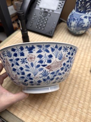 Lot 12 - A Chinese blue and white and copper-red 'fish' bowl, Qing dynasty, Kangxi period