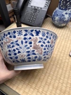 Lot 12 - A Chinese blue and white and copper-red 'fish' bowl, Qing dynasty, Kangxi period