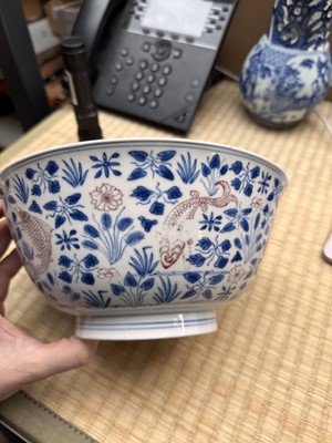 Lot 12 - A Chinese blue and white and copper-red 'fish' bowl, Qing dynasty, Kangxi period