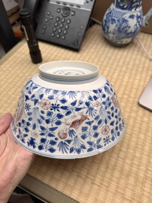 Lot 12 - A Chinese blue and white and copper-red 'fish' bowl, Qing dynasty, Kangxi period
