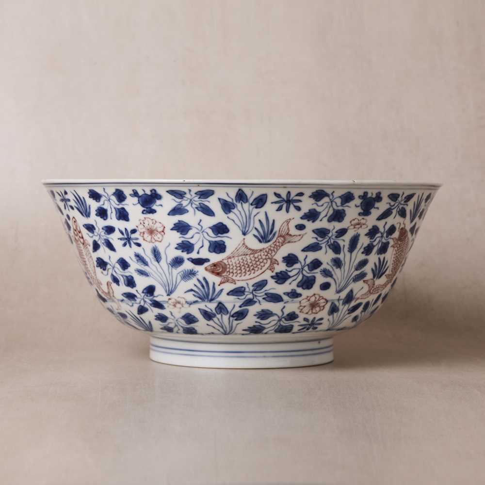 Lot 12 - A Chinese blue and white and copper-red 'fish' bowl, Qing dynasty, Kangxi period