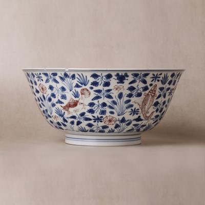 Lot 12 - A Chinese blue and white and copper-red 'fish' bowl, Qing dynasty, Kangxi period