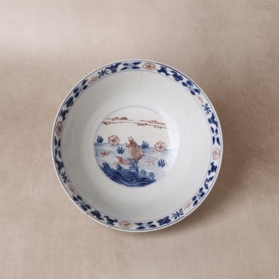 Lot 12 - A Chinese blue and white and copper-red 'fish' bowl, Qing dynasty, Kangxi period